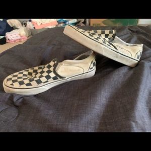 Black and white checkerboard vans slip on